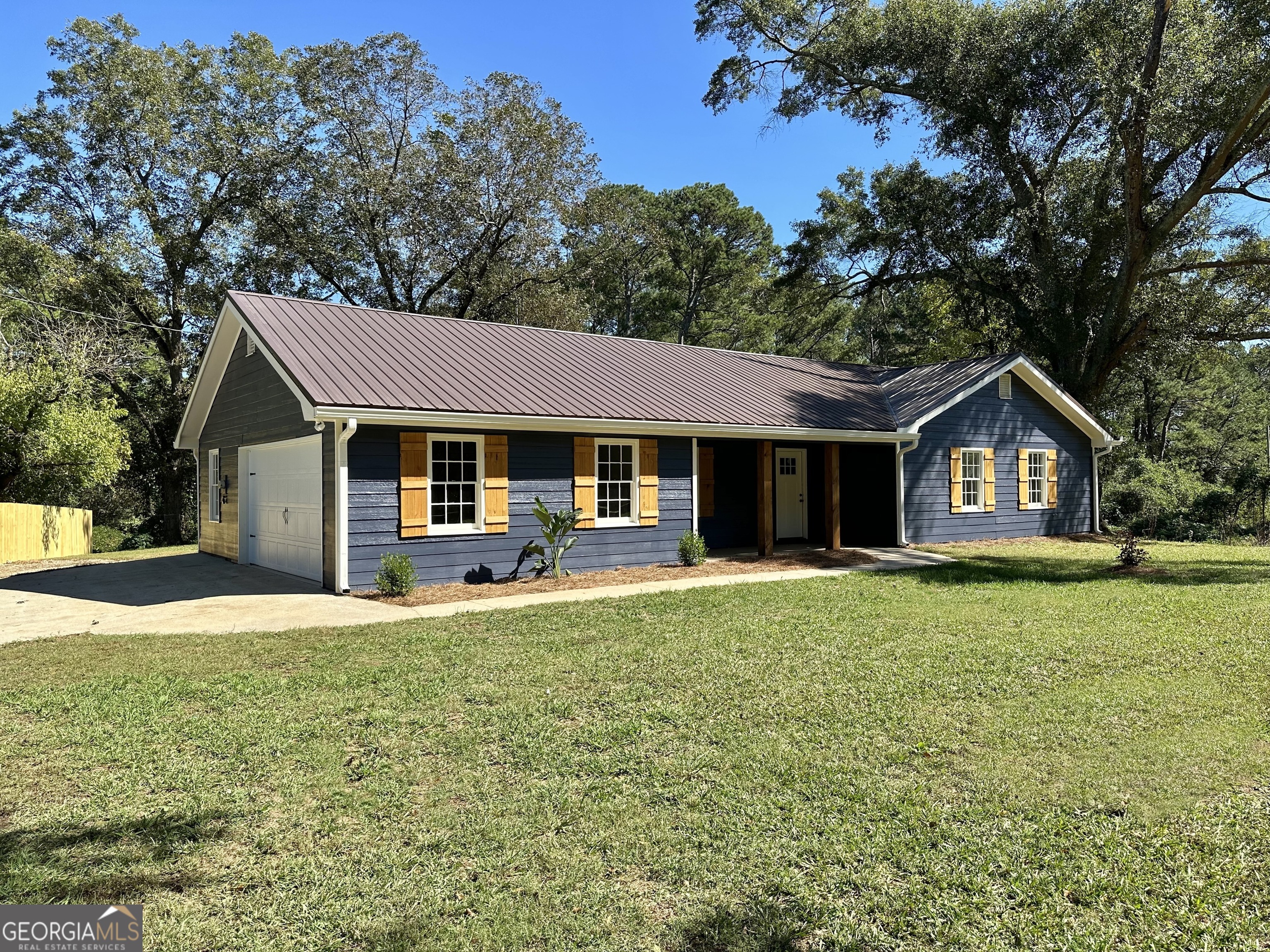 a front view of a house with a garden and porch