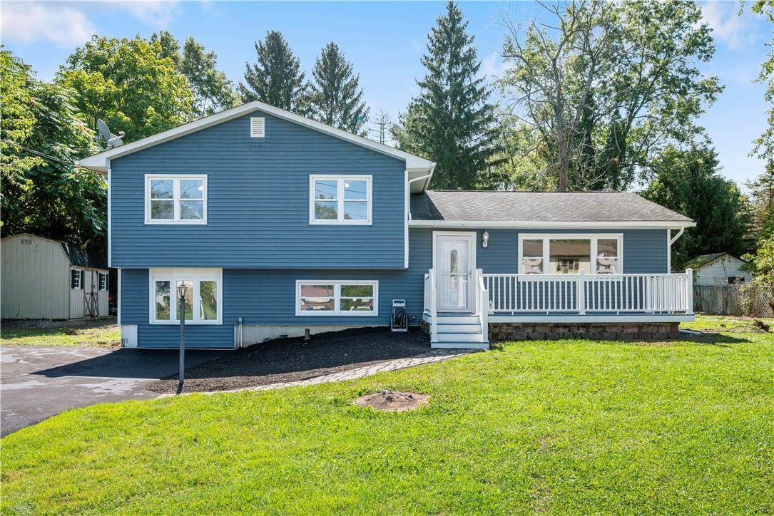 Tri-level home with a new driveway and beautiful front yard.