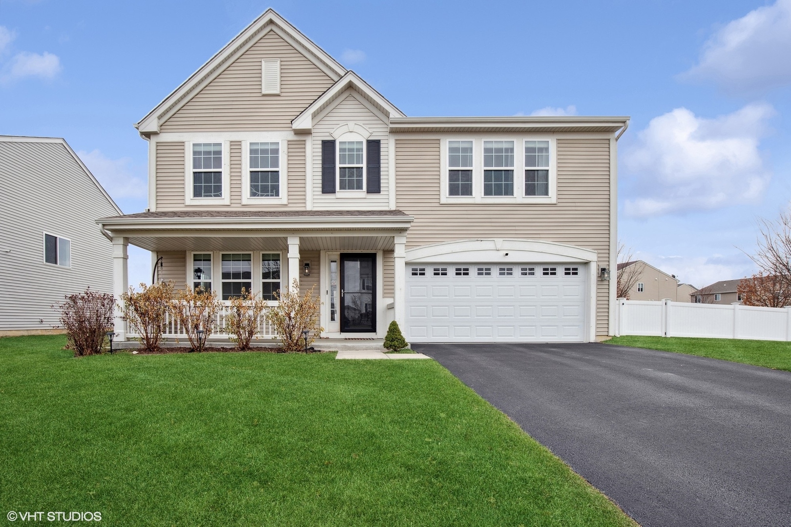 a front view of house with yard and green space