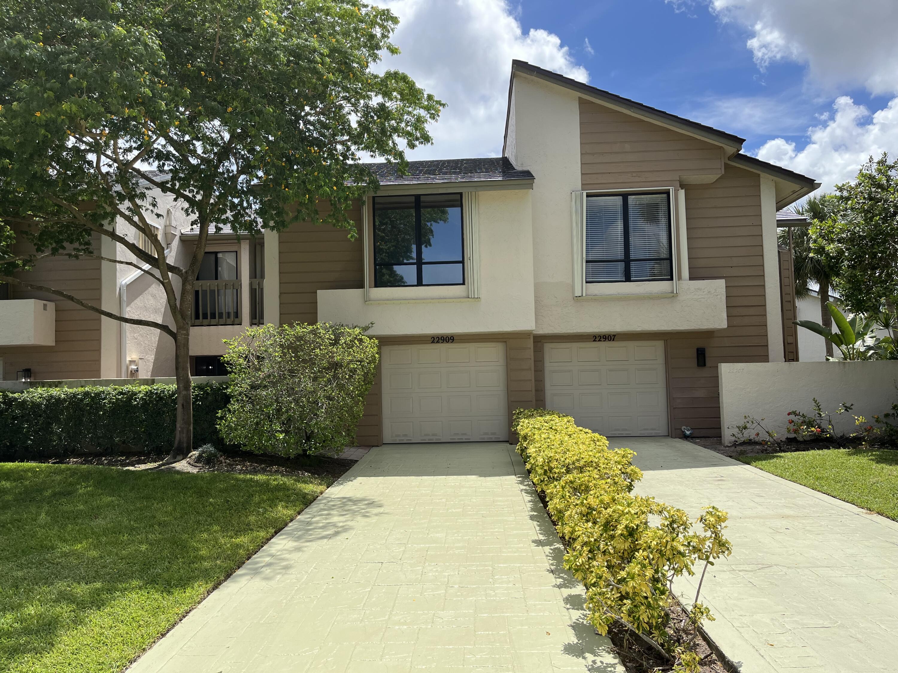 a front view of a house with a garden