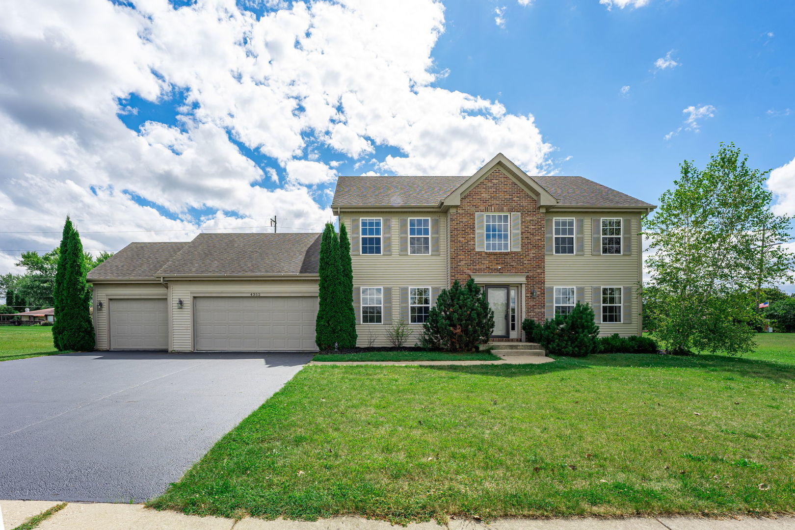 a front view of house with yard and green space