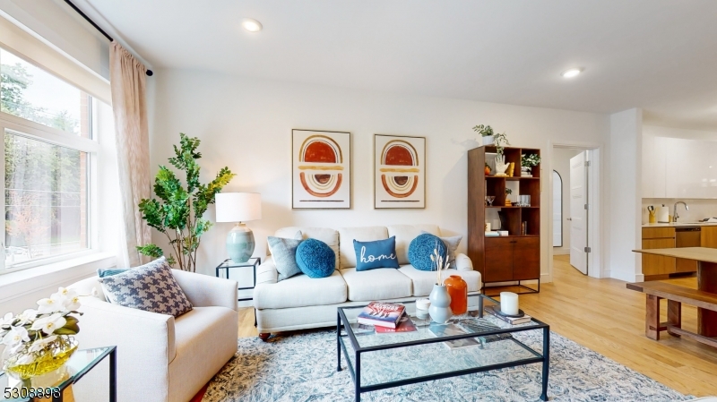 a living room with furniture and book shelf