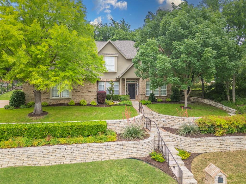 a view of a house with a swimming pool and a yard