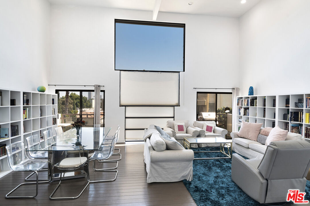 a living room with furniture and large window