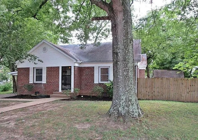 a front view of house with yard and trees