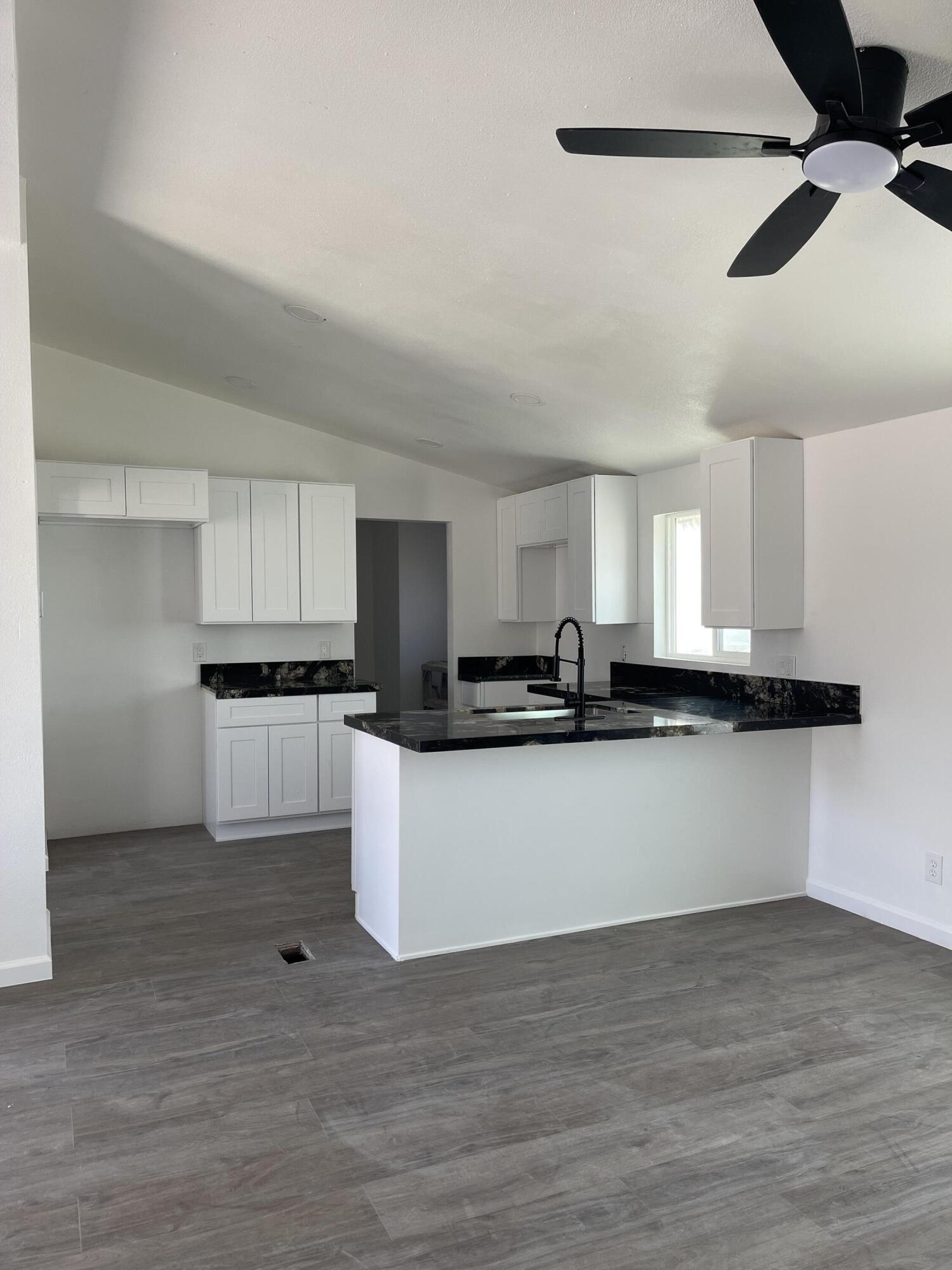 a view of kitchen with sink microwave and stove