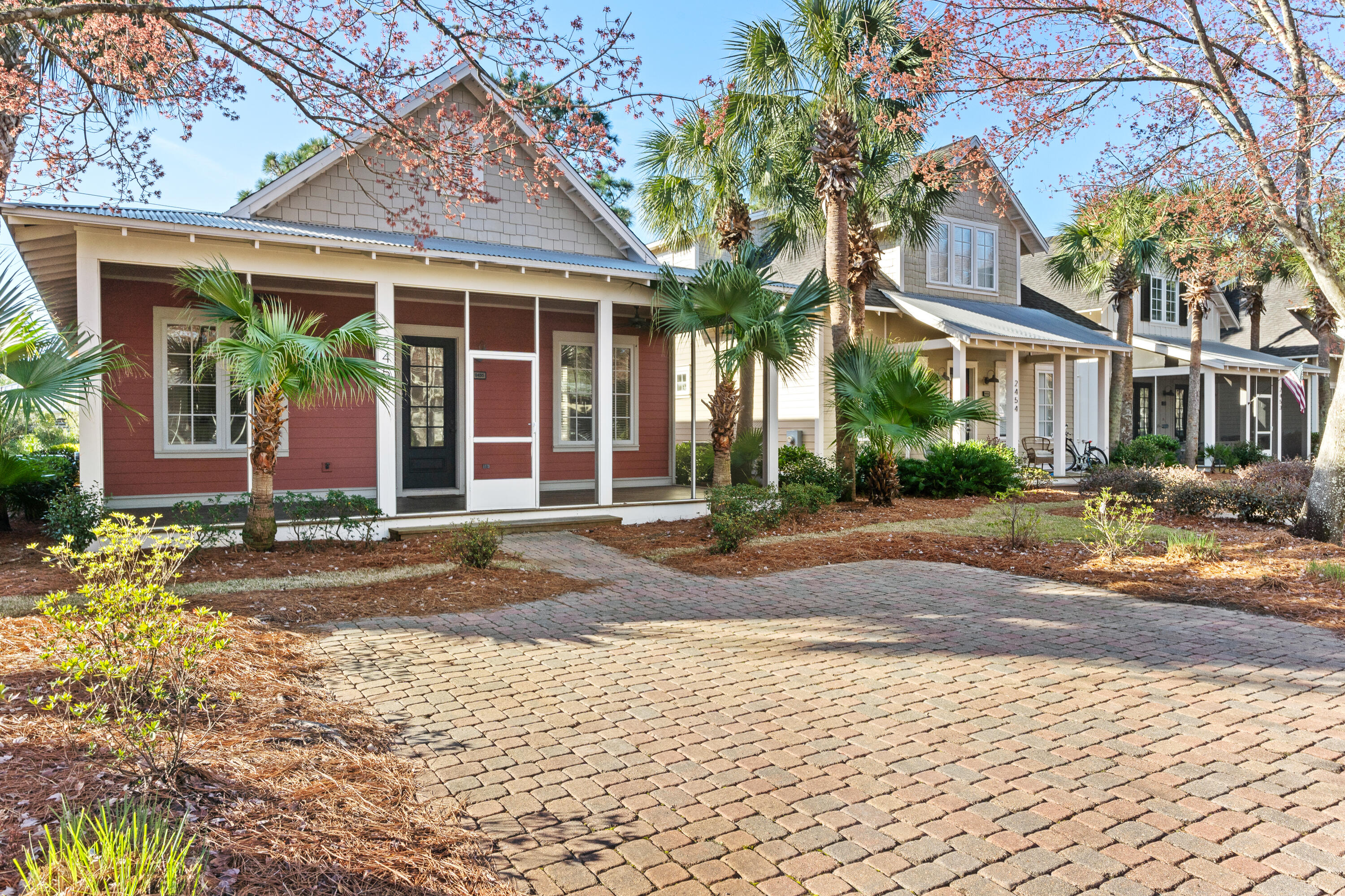 front view of a brick house with a yard