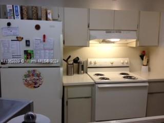 a kitchen with stainless steel appliances granite countertop a sink and a stove