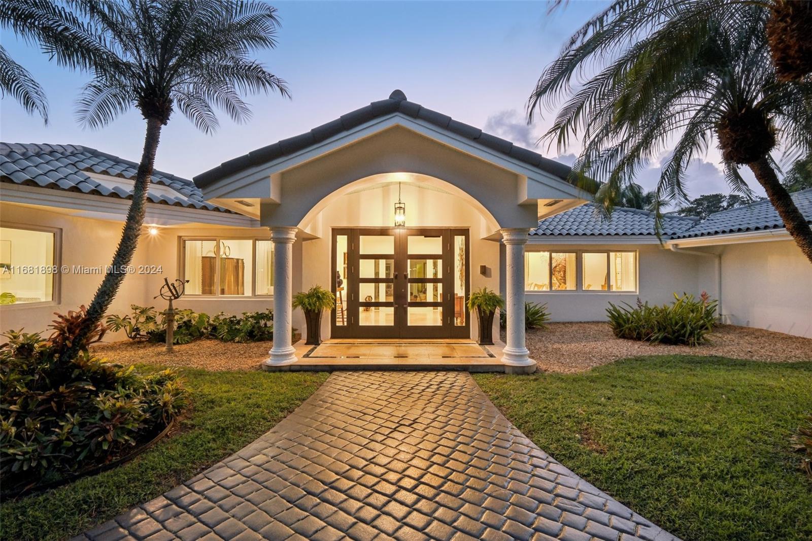 a front view of a house with garden