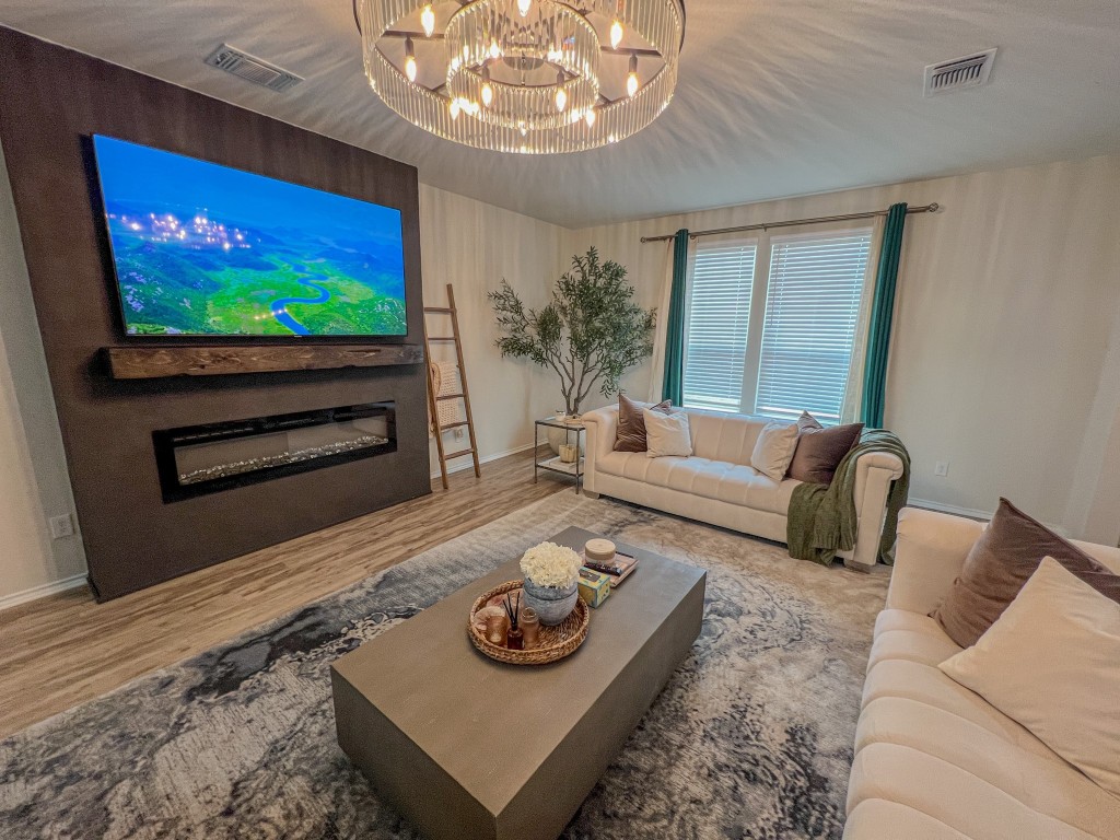 a living room with furniture and a flat screen tv