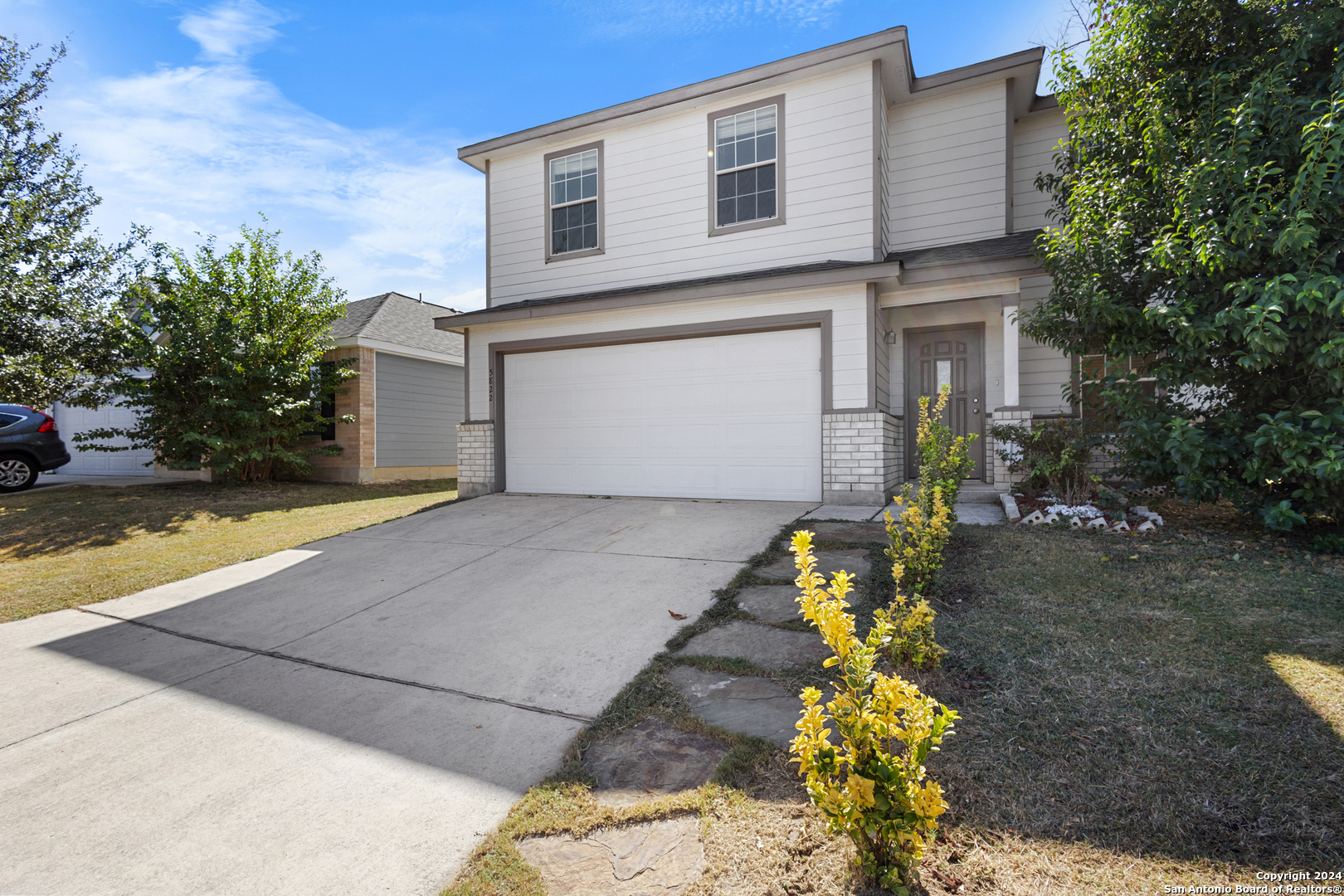 a front view of a house with a yard