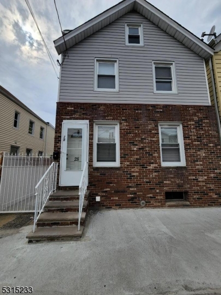 a view of a house with stairs and a car parked