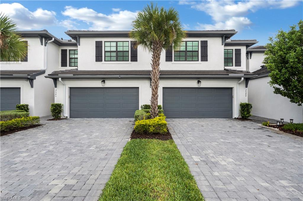 View of front of house with the attached garage.