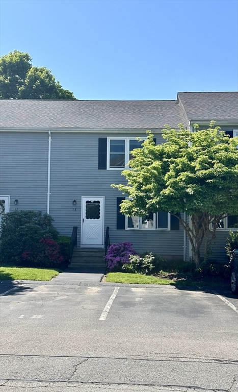 a front view of a house with a yard and a garage