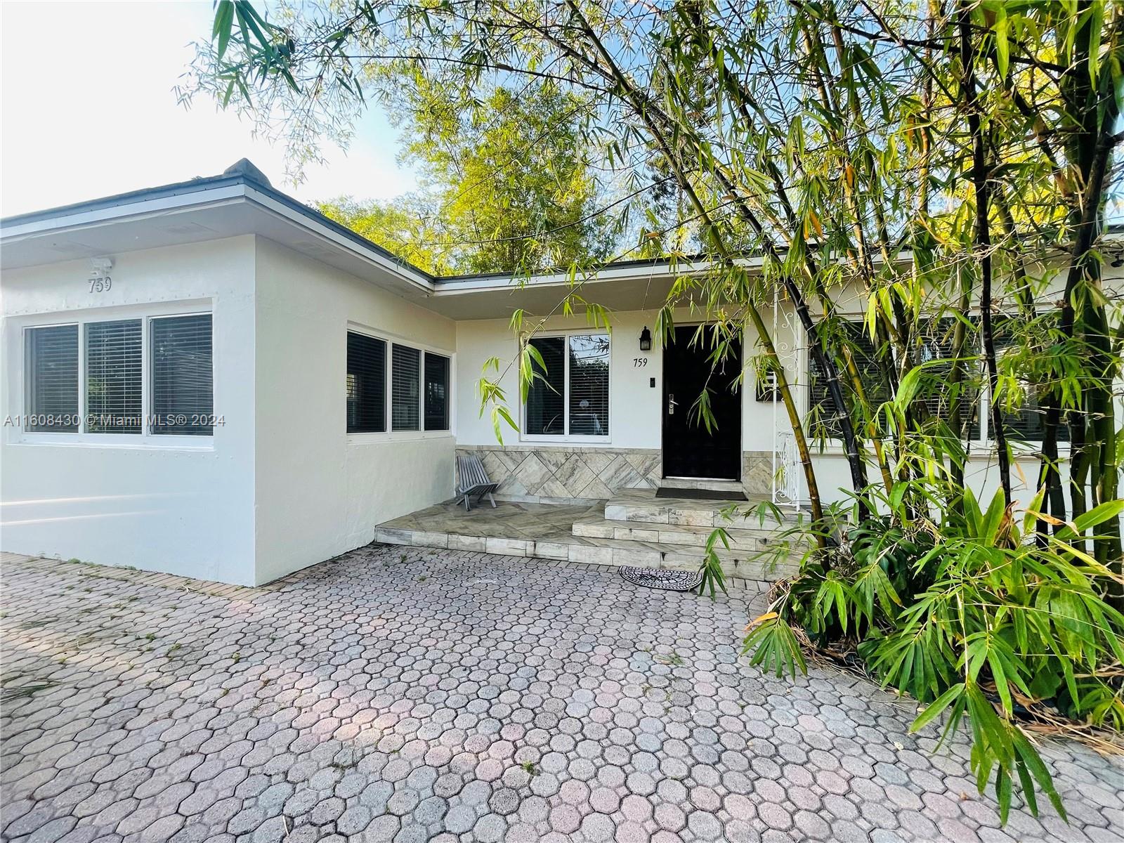 a view of a house with a backyard