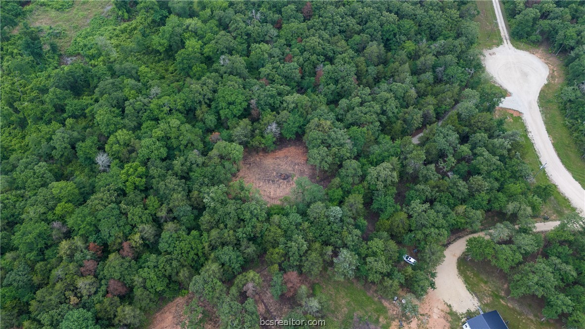 an aerial view of a house with lots of trees
