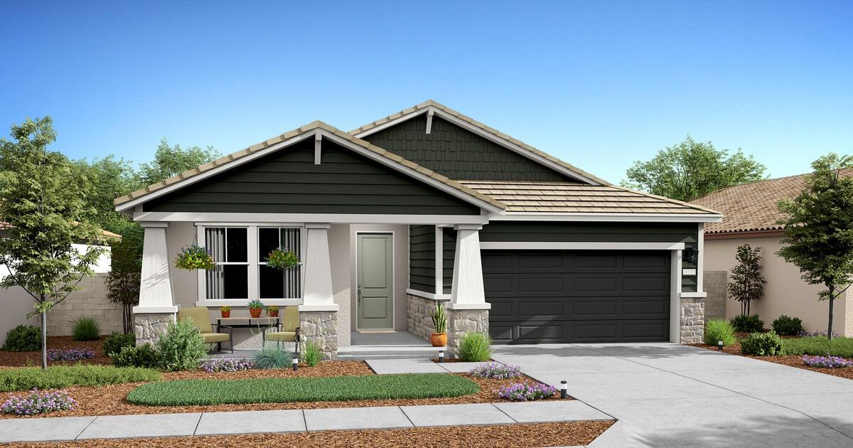 a front view of a house with a yard outdoor seating and garage