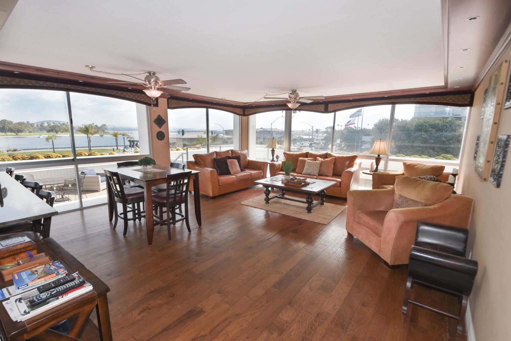 a very nice looking living room with furniture and floor to ceiling windows