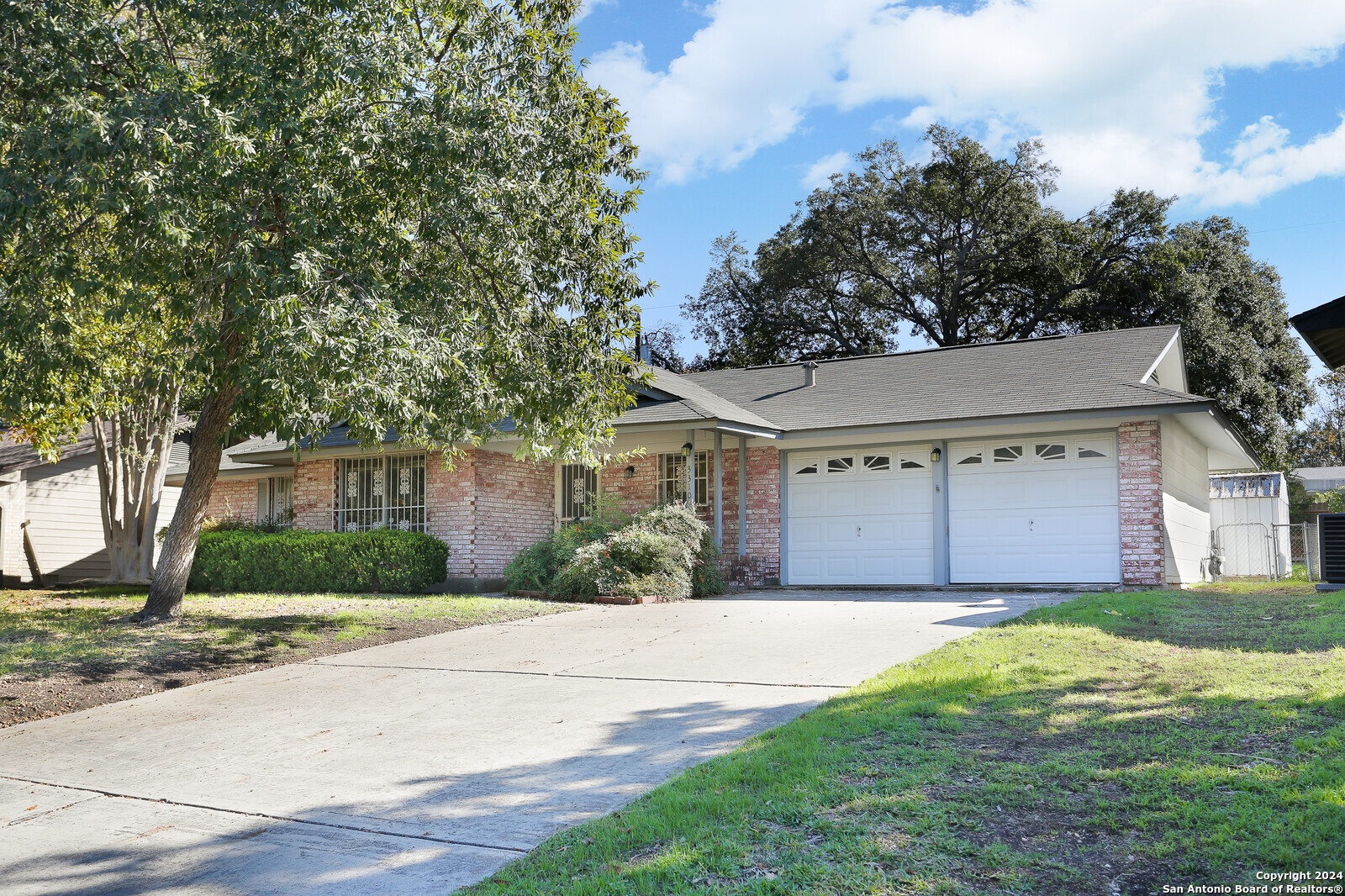 a front view of house with yard and trees