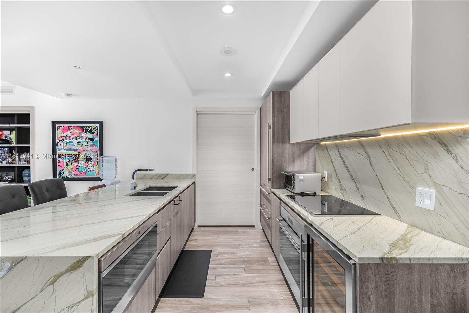 a kitchen with stainless steel appliances granite countertop a sink and stove