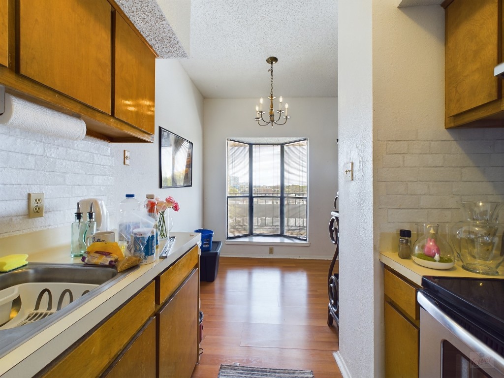 a kitchen with a sink a stove and cabinets