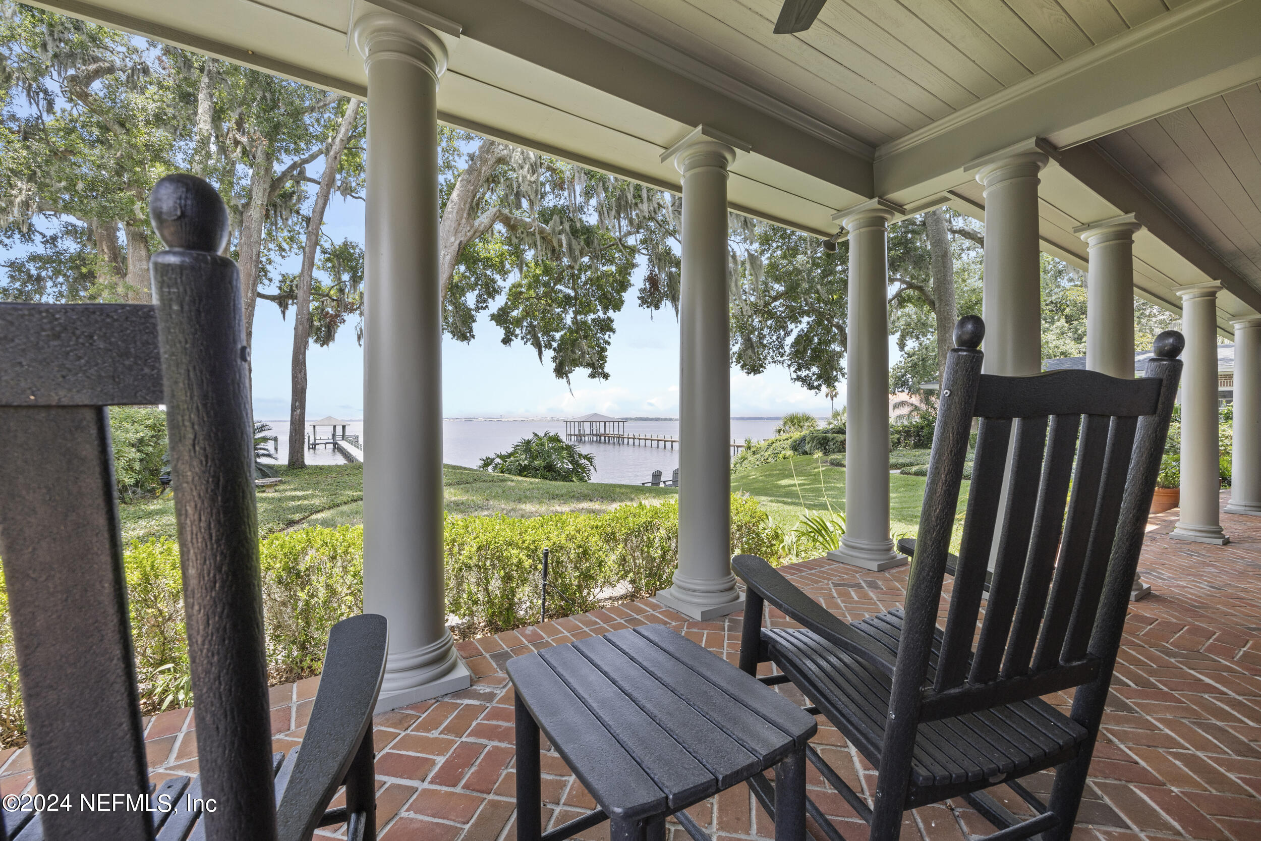 a view of a porch with furniture and wooden floor