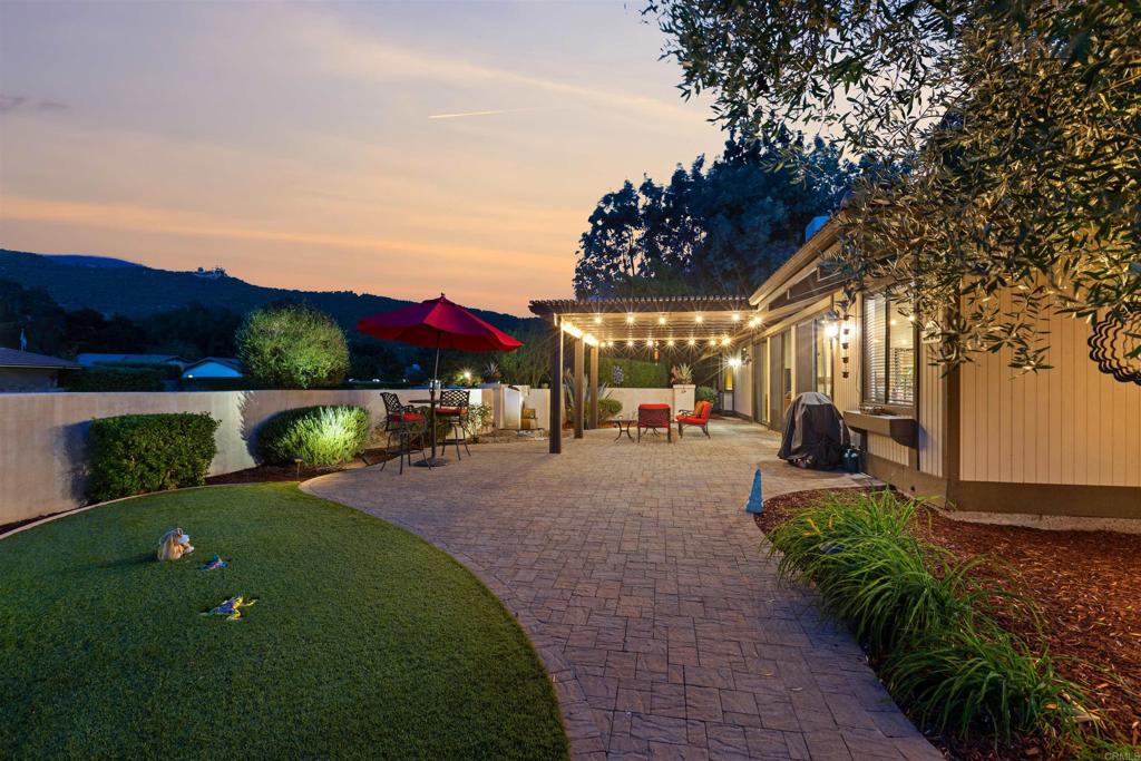 a view of a backyard with sitting area