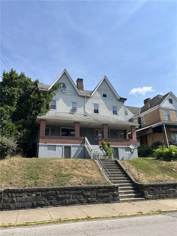 a front view of a house with garden