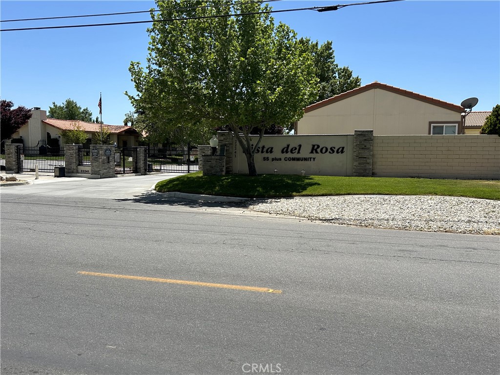 a view of street along with house and trees