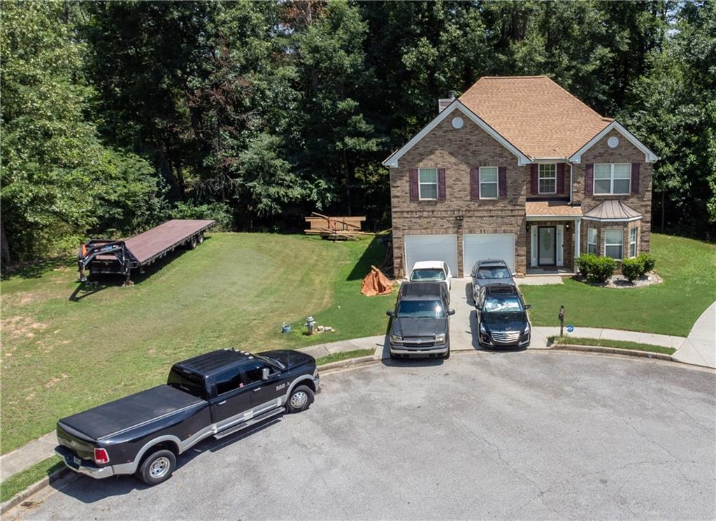 an aerial view of a house with swimming pool and porch