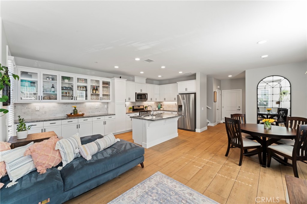 a living room with stainless steel appliances kitchen island granite countertop furniture and a kitchen view