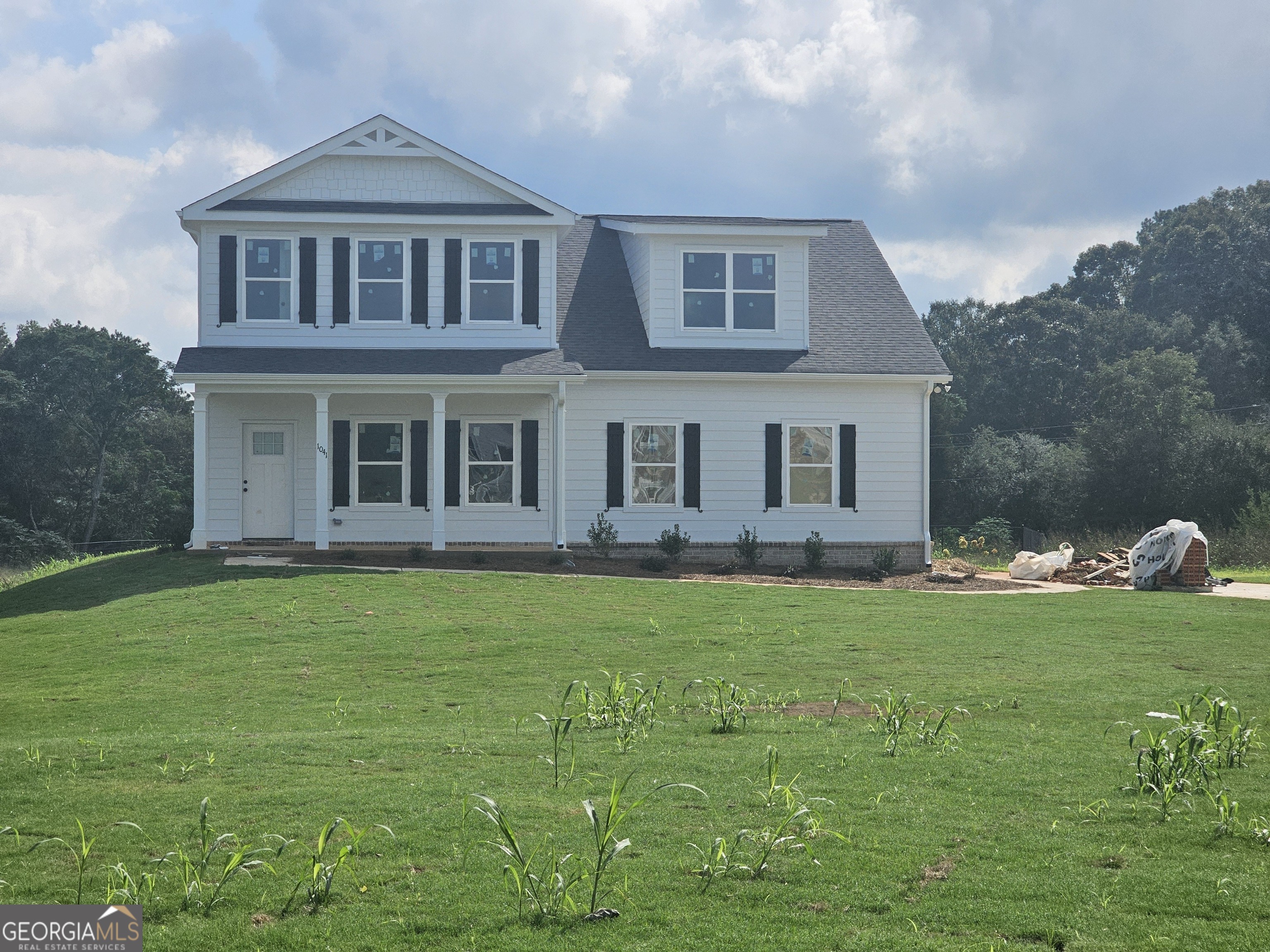 a front view of a house with a garden