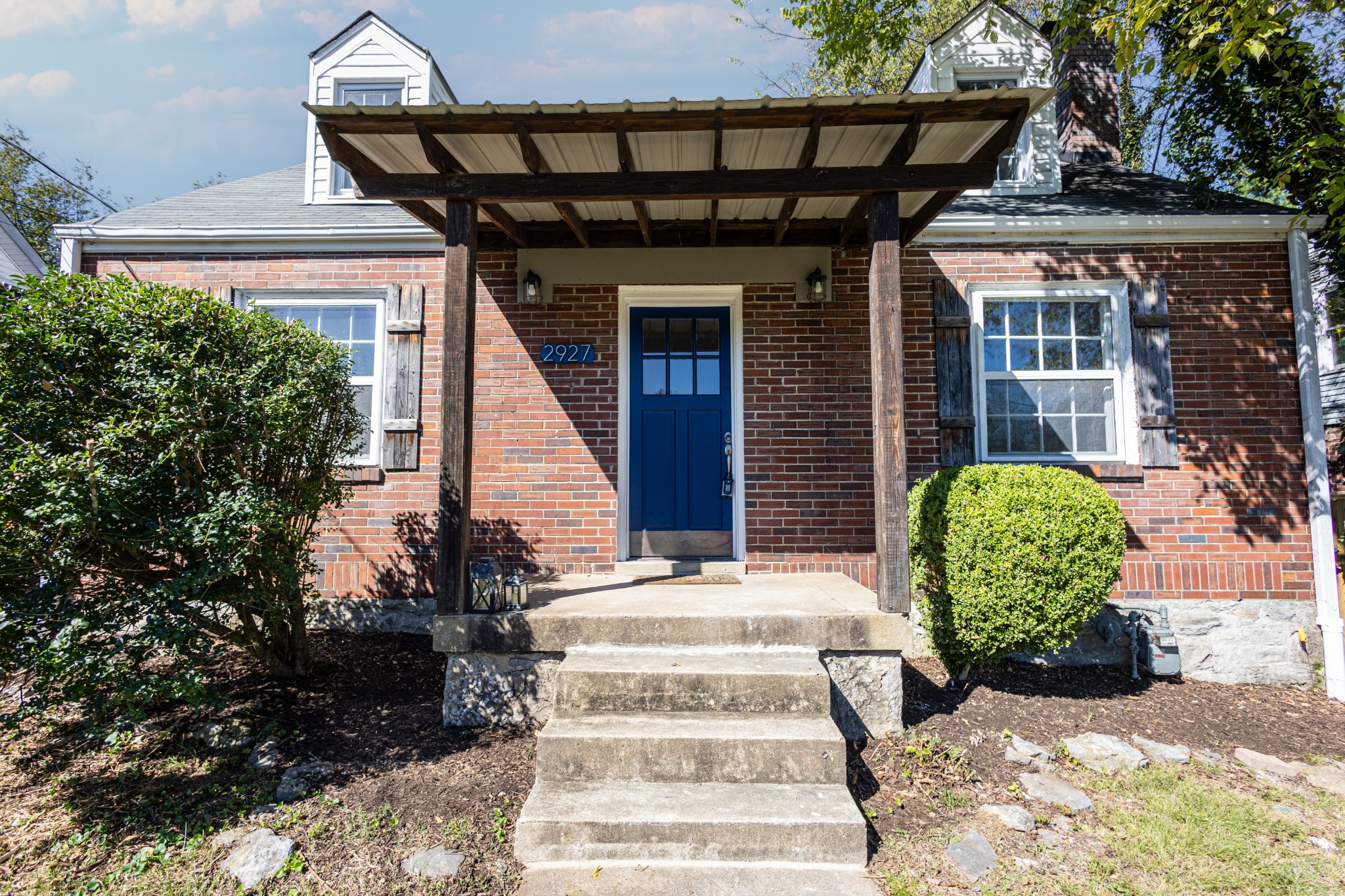 a front view of a house with garden