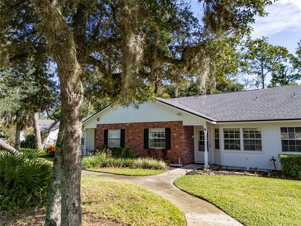 a front view of a house with a yard and porch