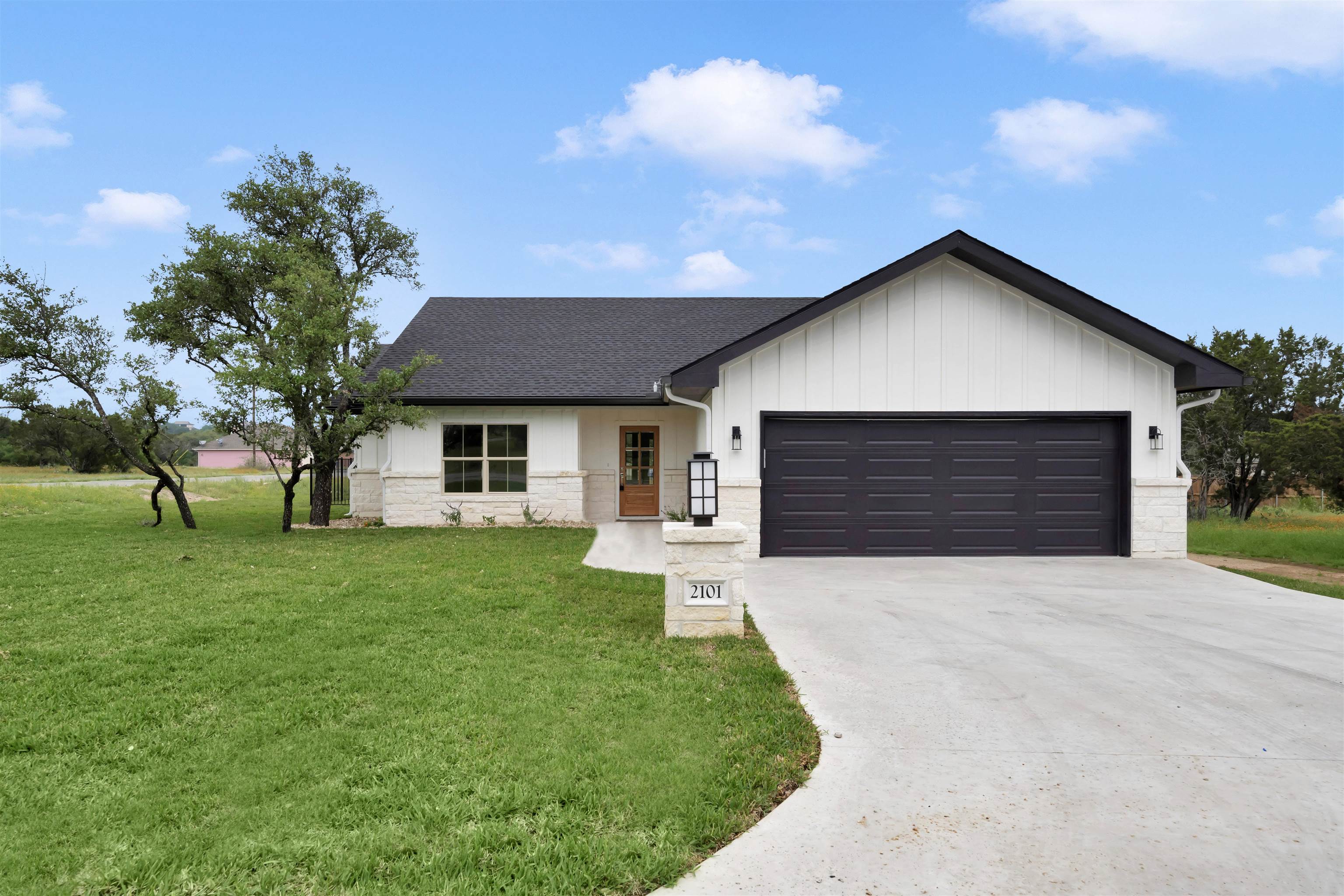 a front view of a house with a yard and garage