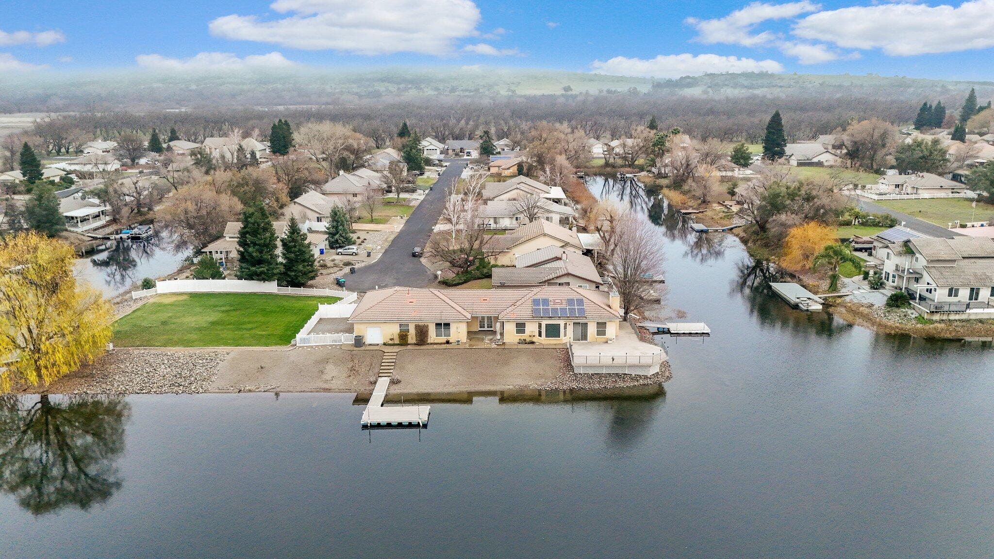 an aerial view of a house with outdoor space lake view and boat