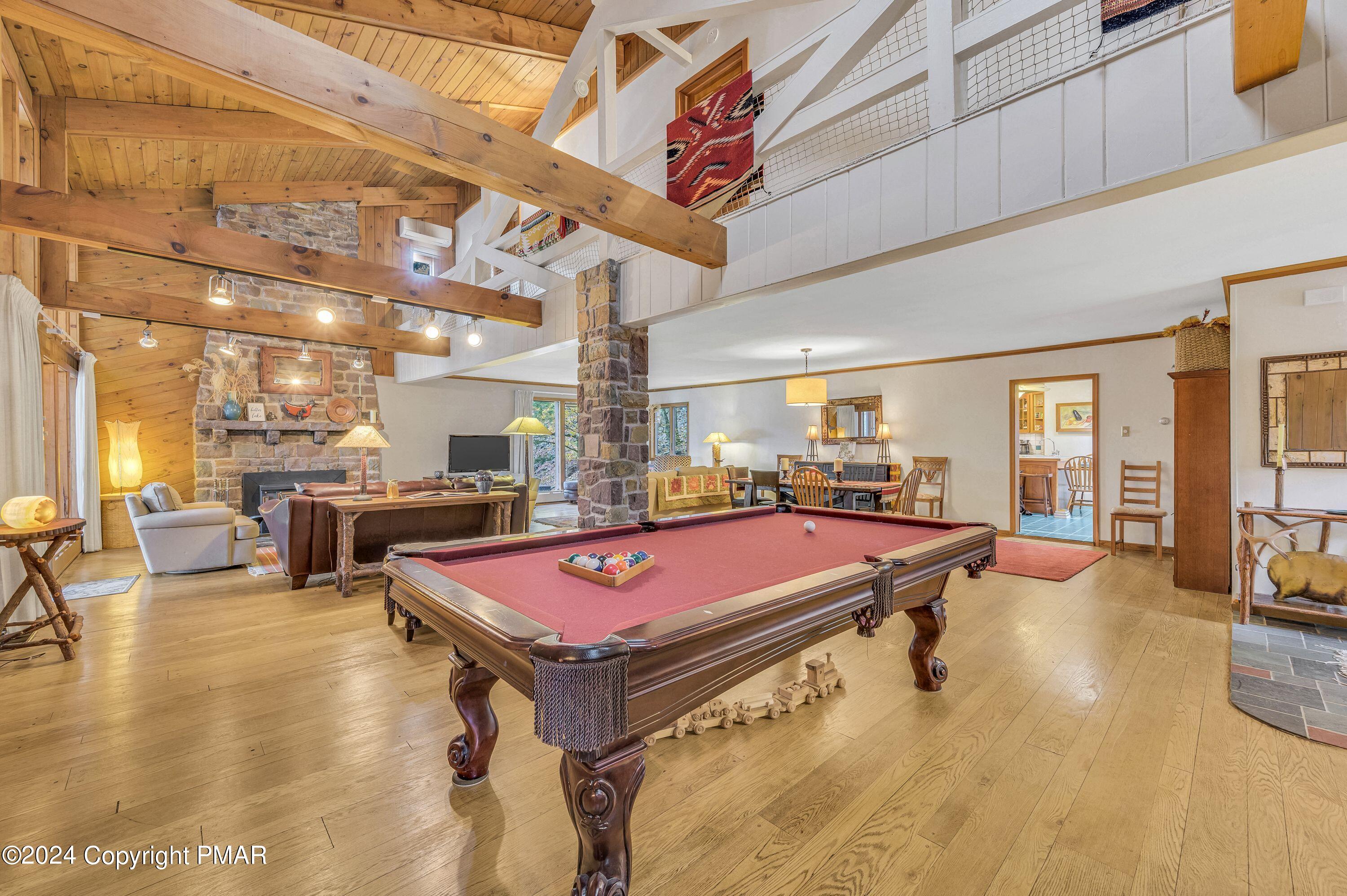 a room with pool table and windows