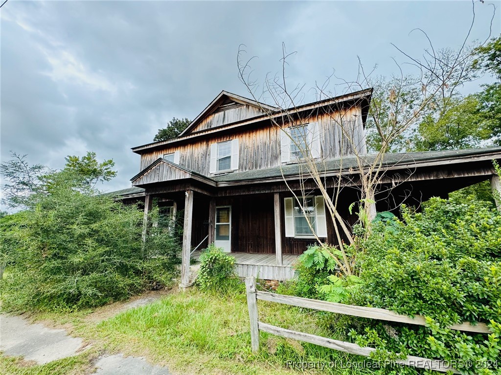 a front view of a house with plants