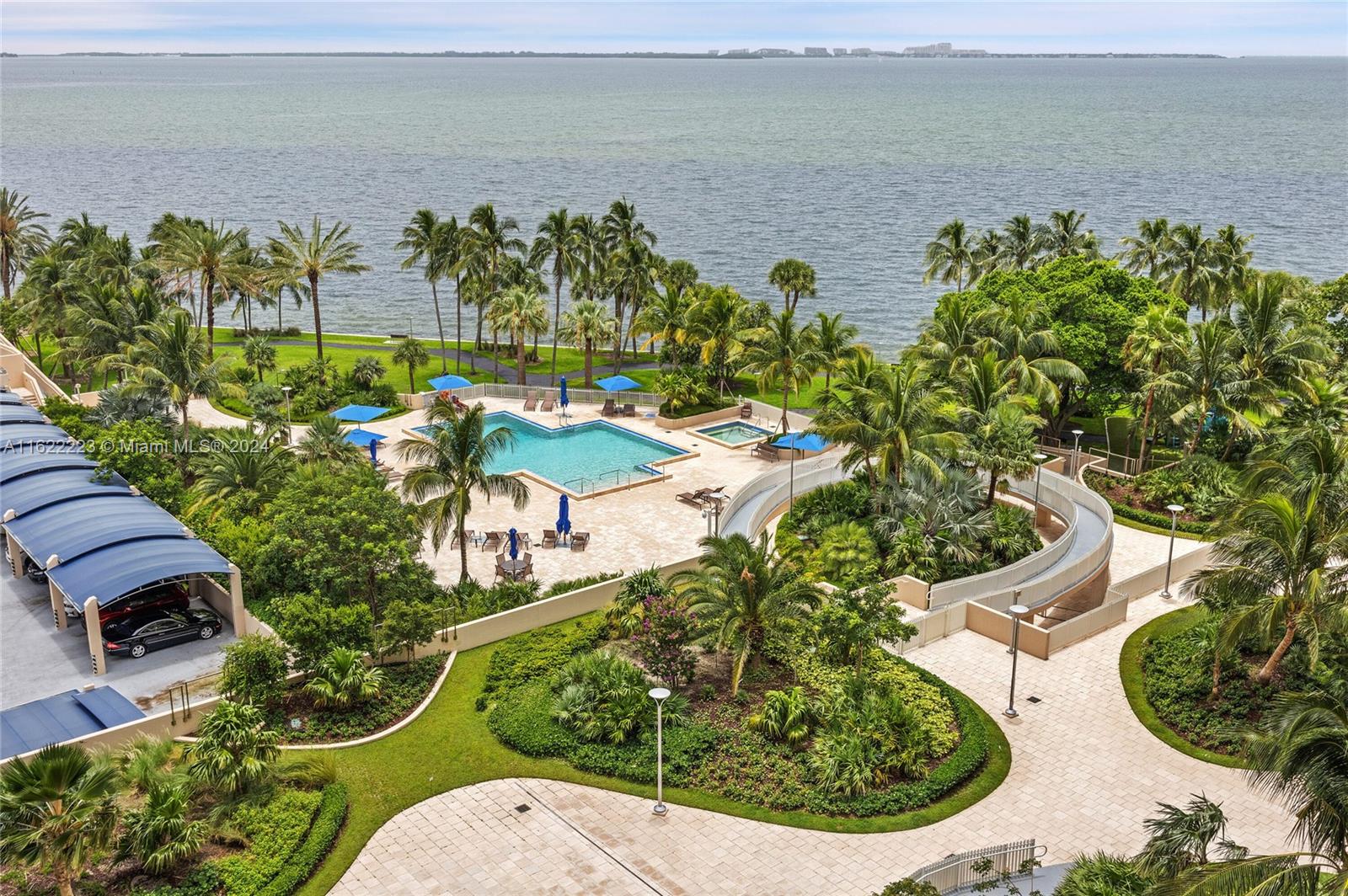 a view of a backyard with plants and lake view