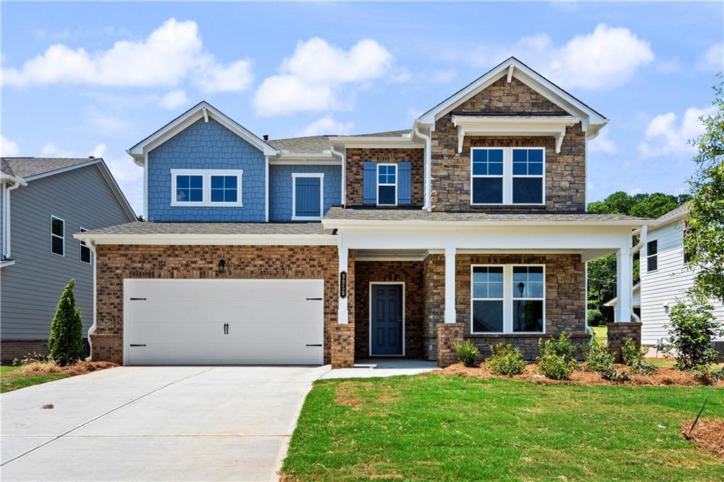 a front view of a house with a yard and garage