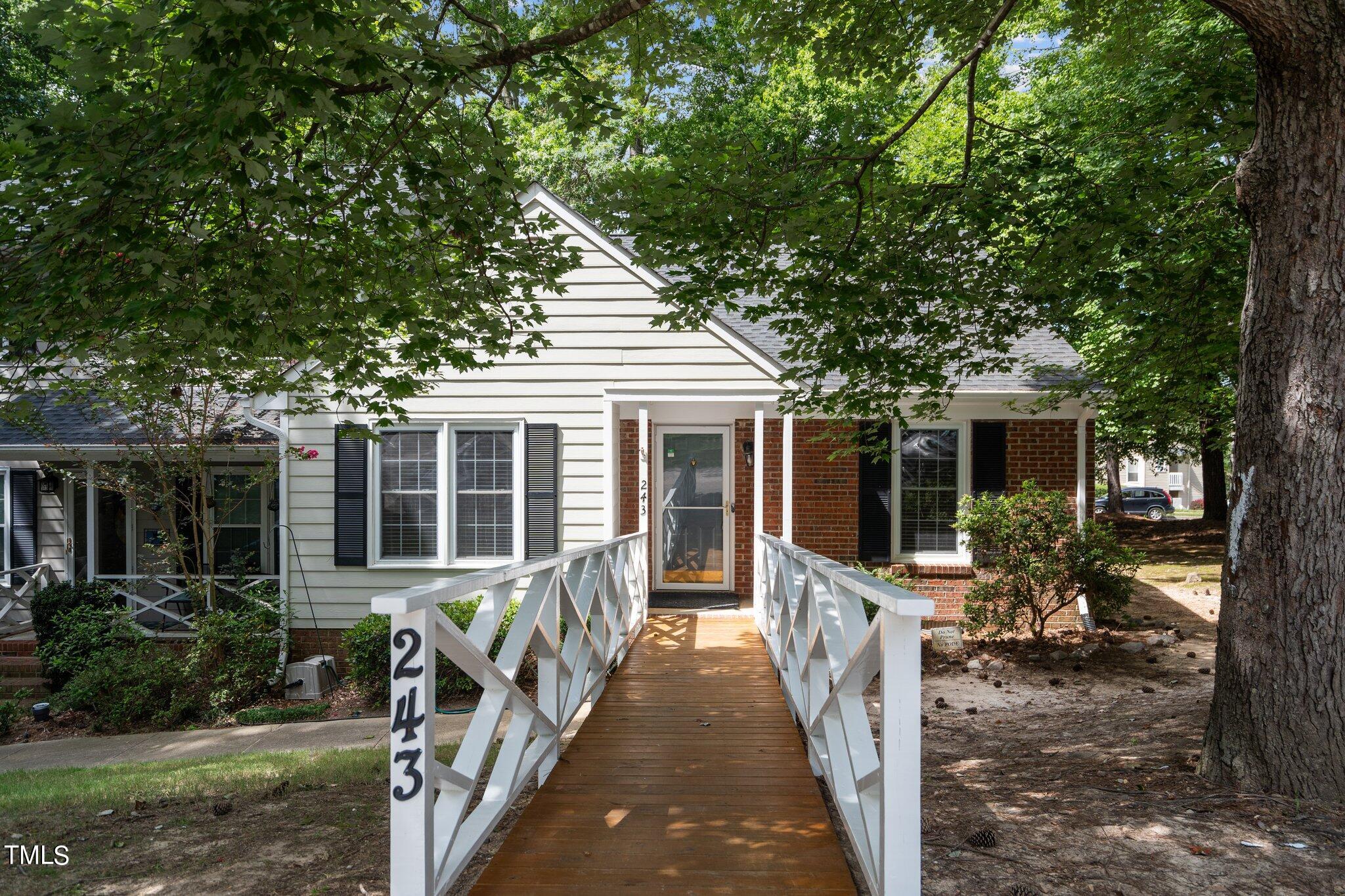 a view of a house with backyard and porch