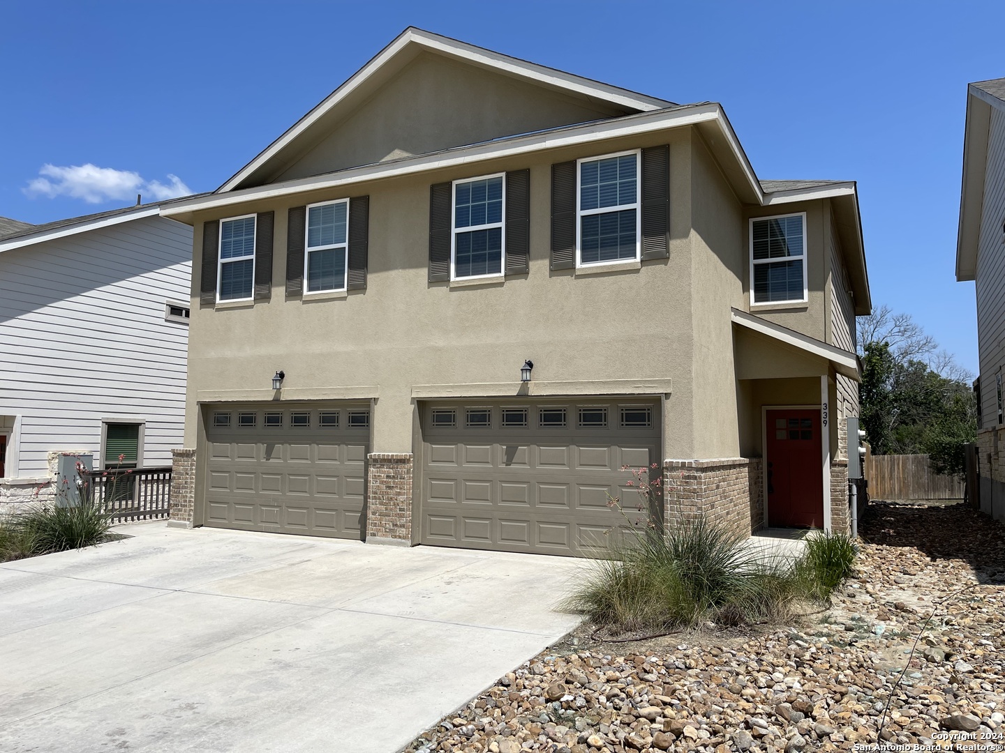 a front view of a house with a yard