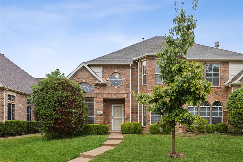 a front view of house with yard and green space