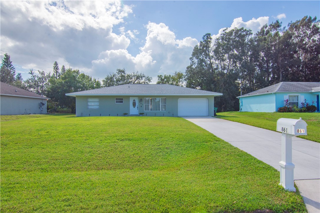 a front view of house with yard swimming pool and green space