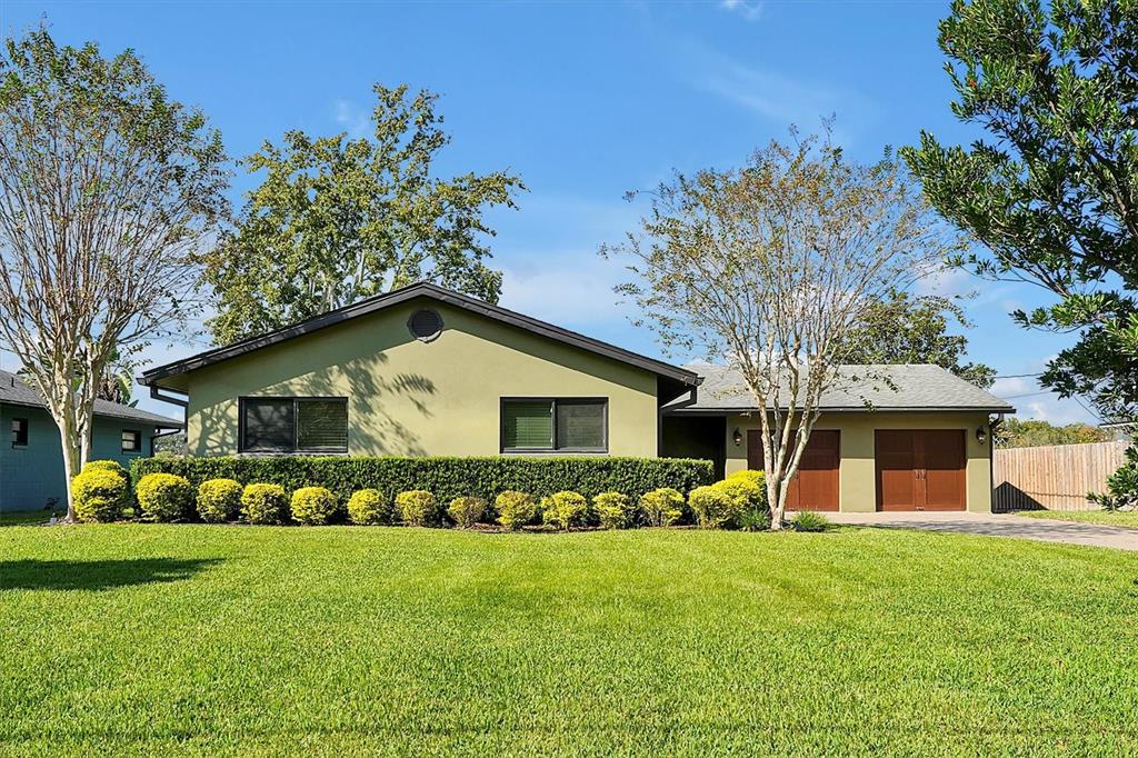 a front view of house with yard and green space