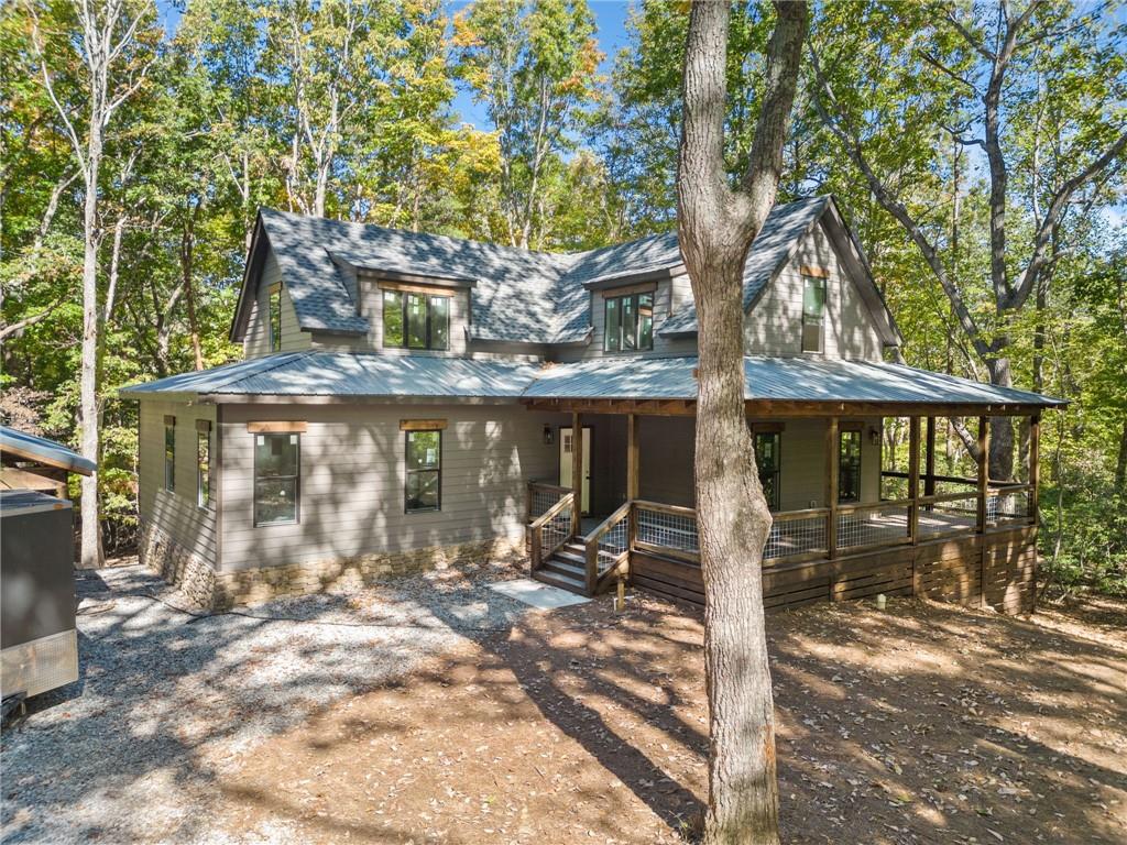 a view of a house with large trees