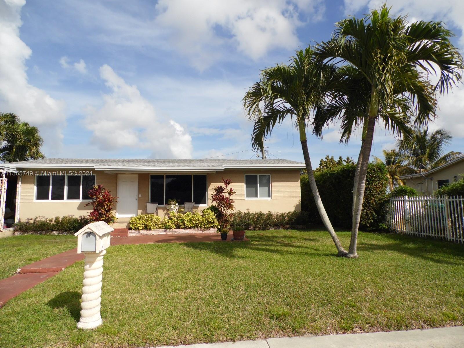 a front view of house with yard slide and outdoor seating