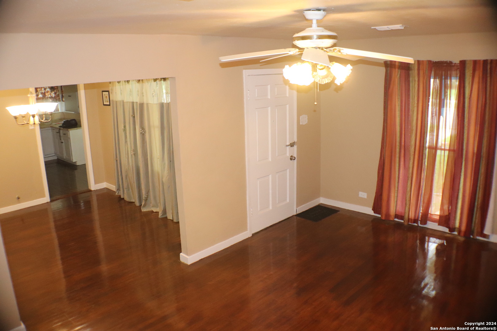 wooden floor in an empty room with a window