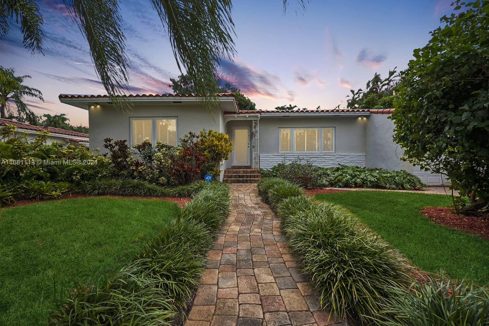 a front view of a house with garden