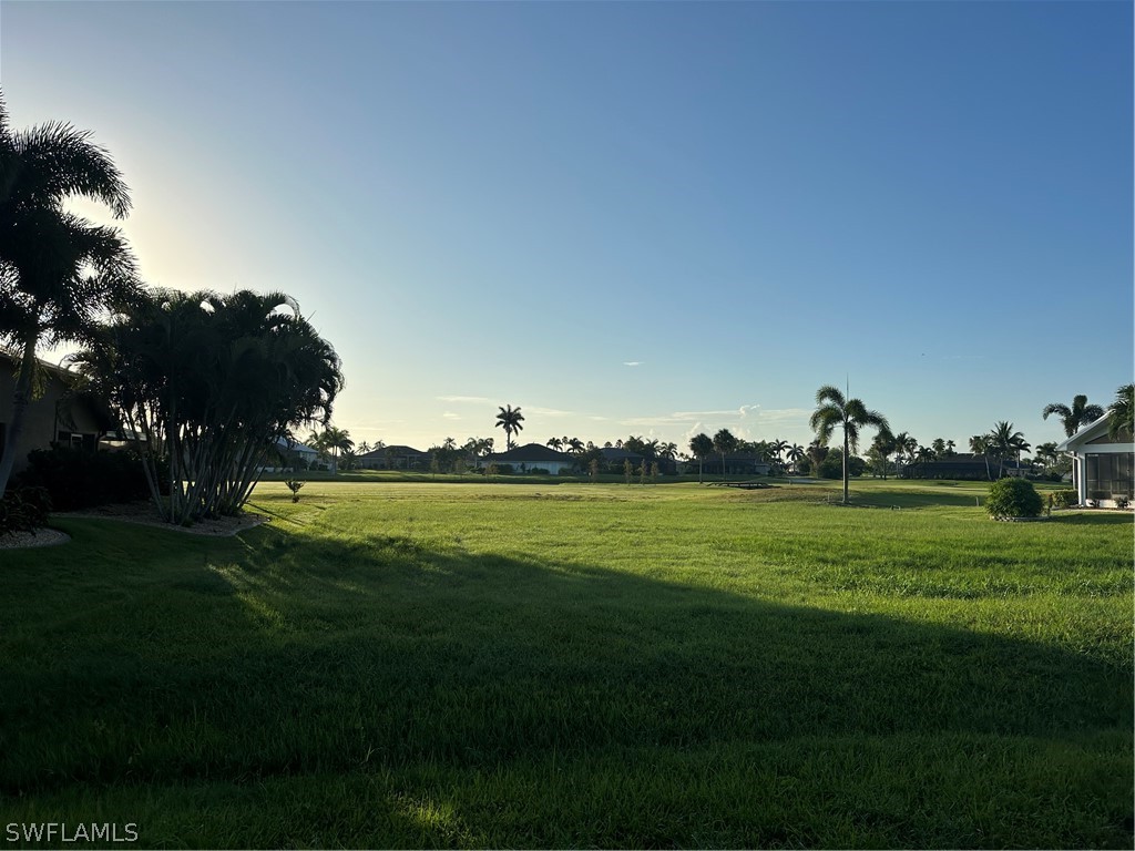 a view of a big yard and an ocean view